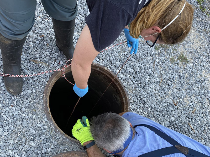 Stusdent collects wastewater sample